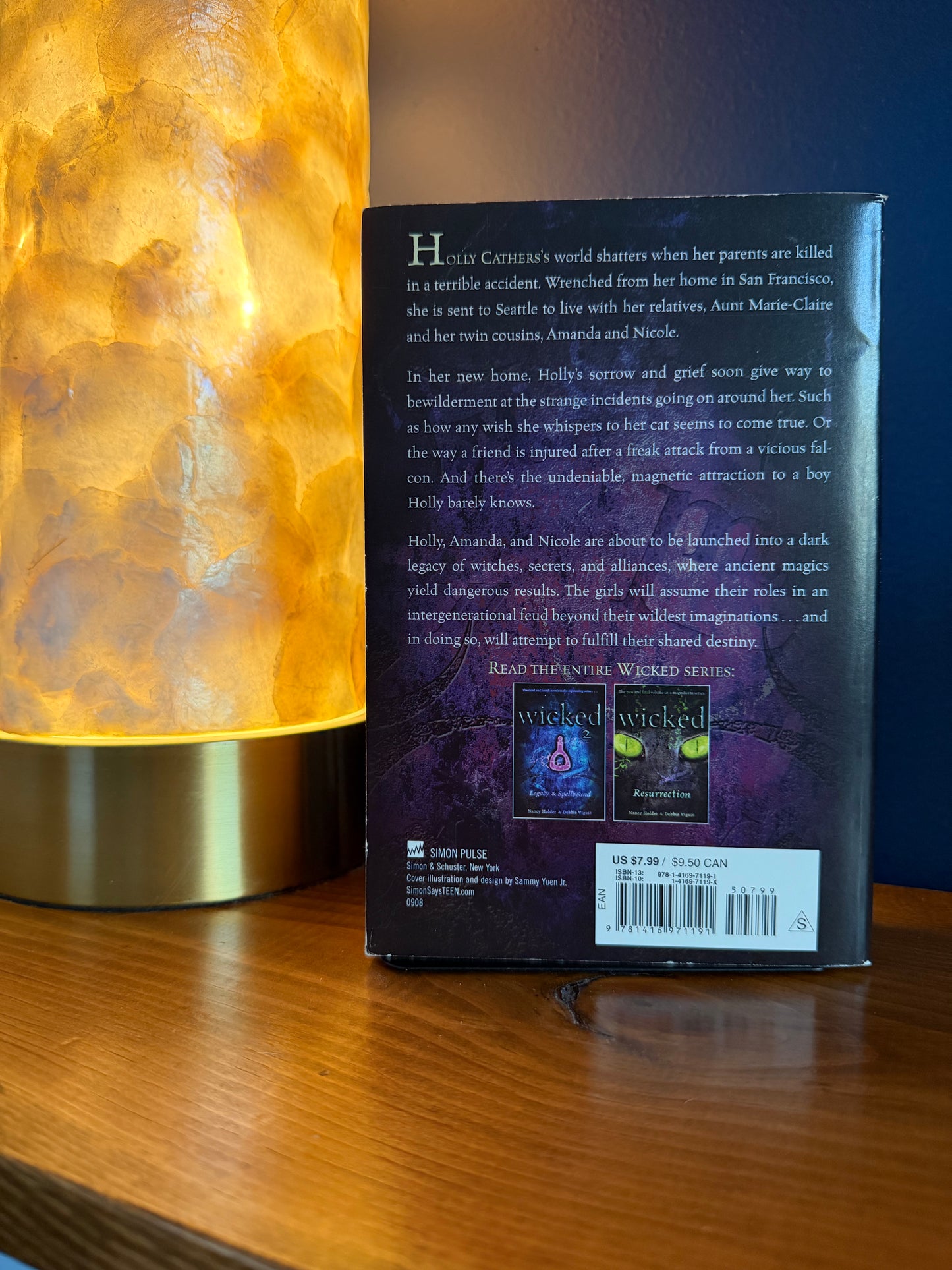 Book with a glowing lamp on a wooden surface