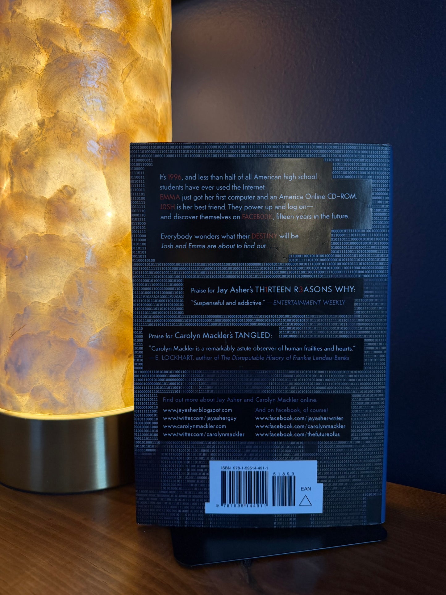 Book back cover with a glowing lamp on a wooden surface