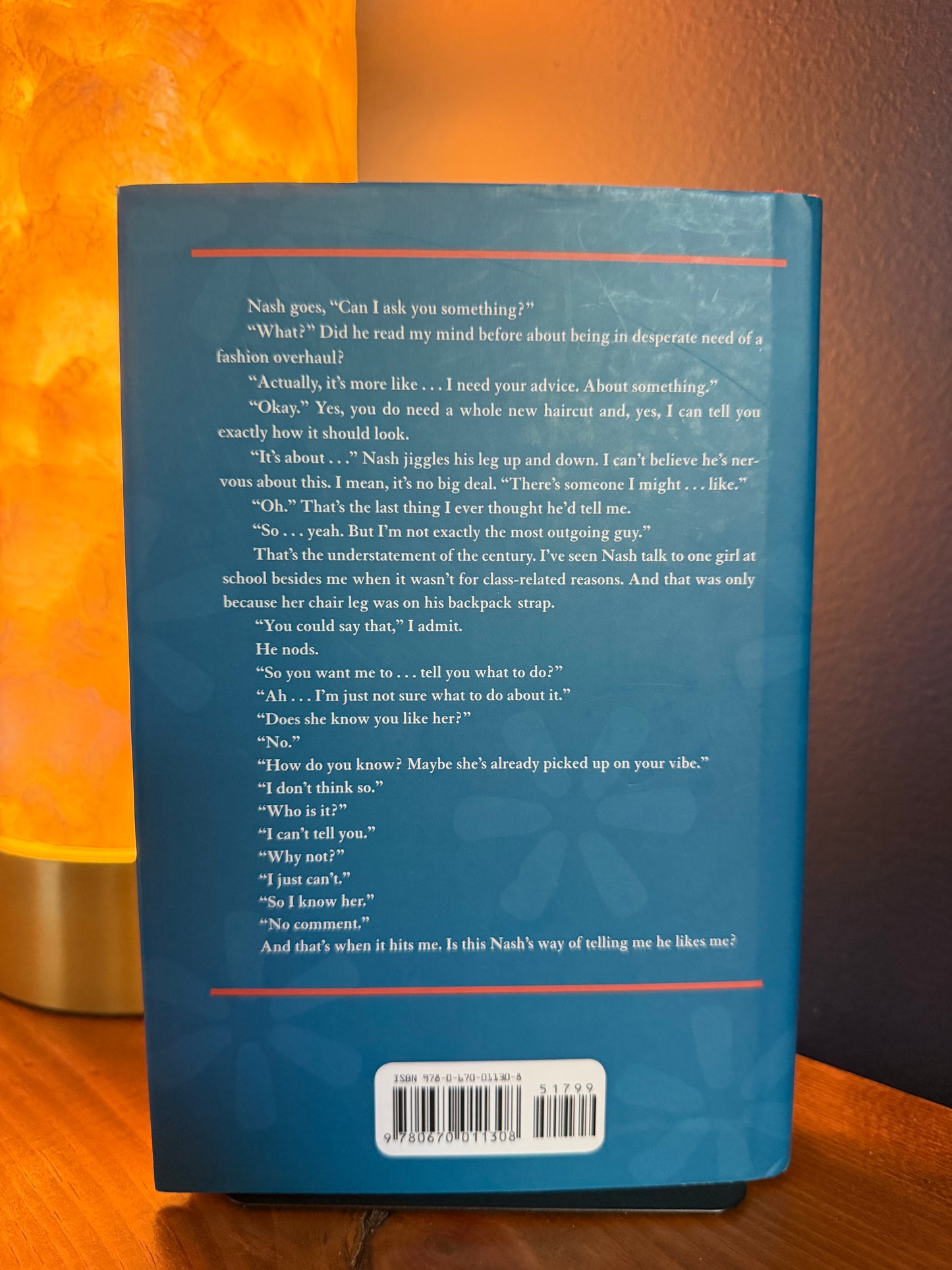 Back cover of a book with text and a barcode on an orange background