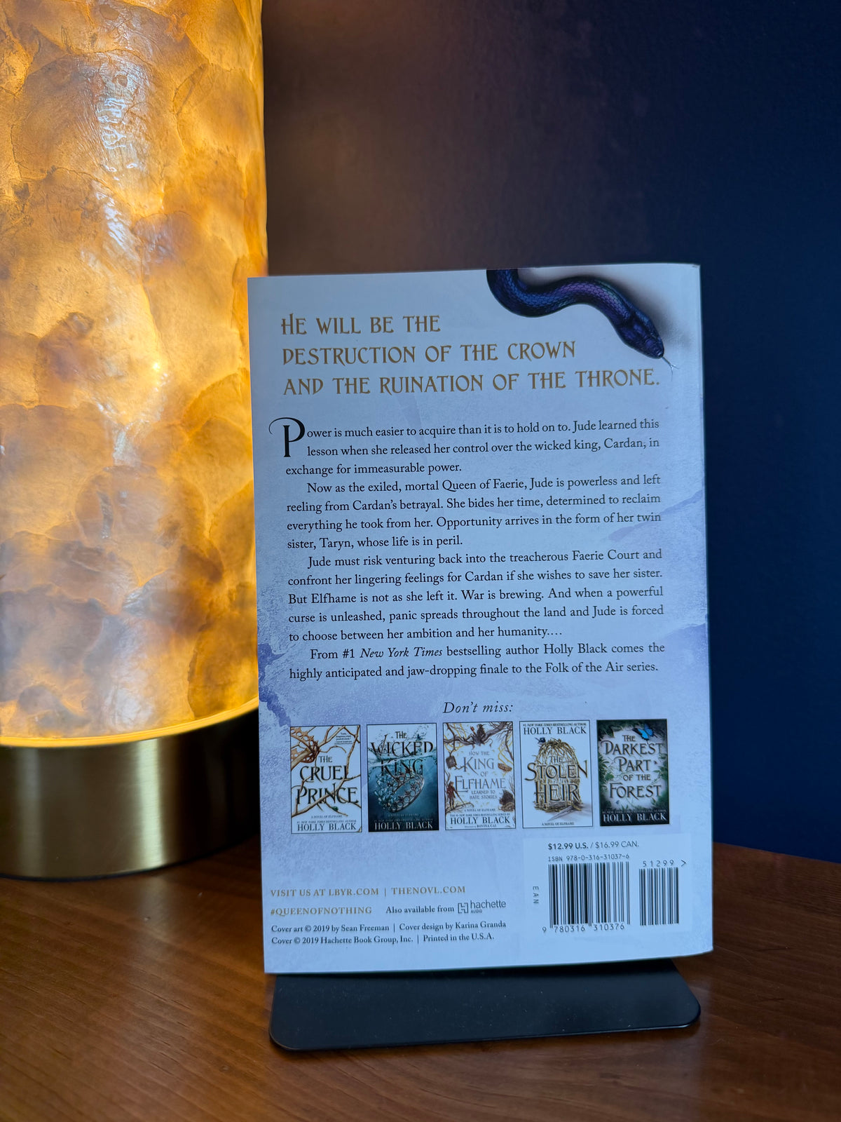 Back cover of a book with text and images on a wooden surface