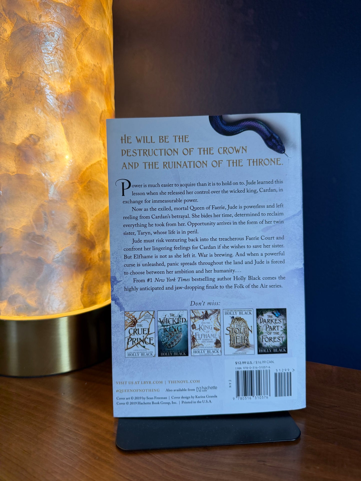 Back cover of a book with text and images on a wooden surface