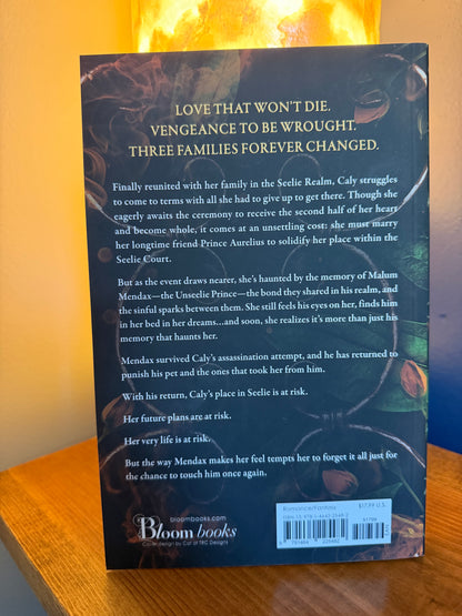 The back cover of a book by Jeneane O'Riley, published by Bloom Books, photographed on a wooden surface. The cover features a dark swirled background.